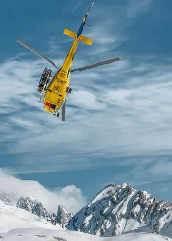 Heliski helicopter flying over the Mont Blanc massif from La Rosière
