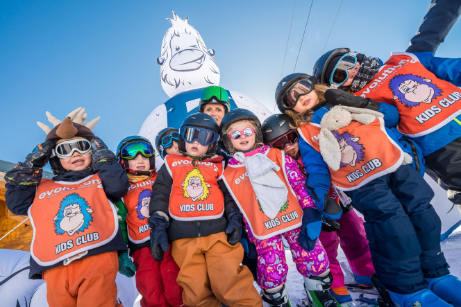 All the children posing for a group photo in front of the Yeti after their ski lesson in Tignes