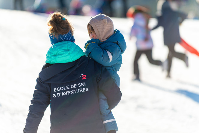 Evolution 2 instructor with a child at the Winter Camp in Megève