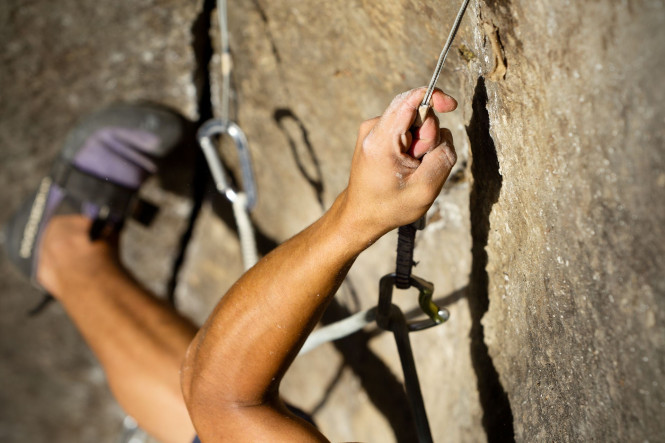 Climber progressing on a rock face.