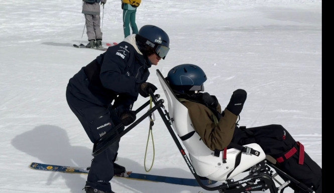 Ski instructor and adaptive skier in a dualski