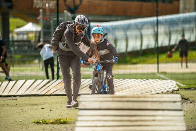 A child learning mountain biking on a track in Tignes with Evolution 2