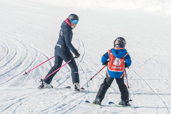 Evolution 2 ski instructor teaching a ski lesson with a child in Tignes