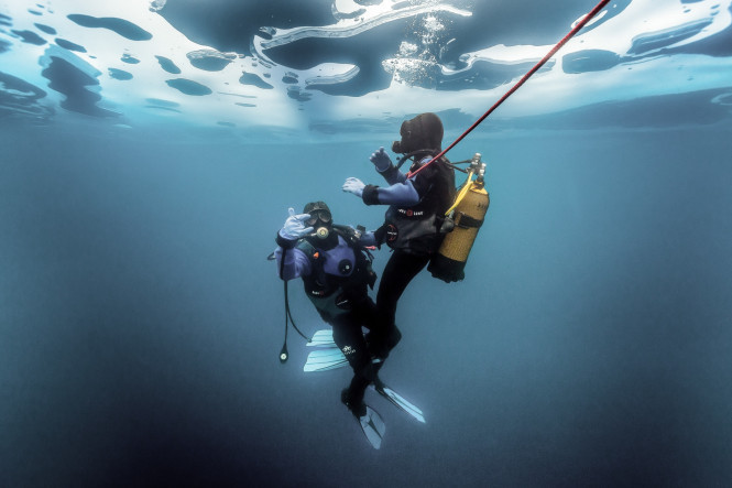 A diver exploring the seabed beneath the ice during an ice dive