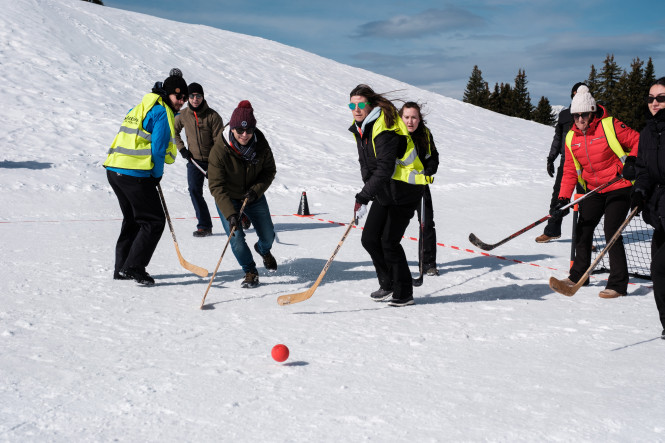 Participants in a seminar playing hockey on snow